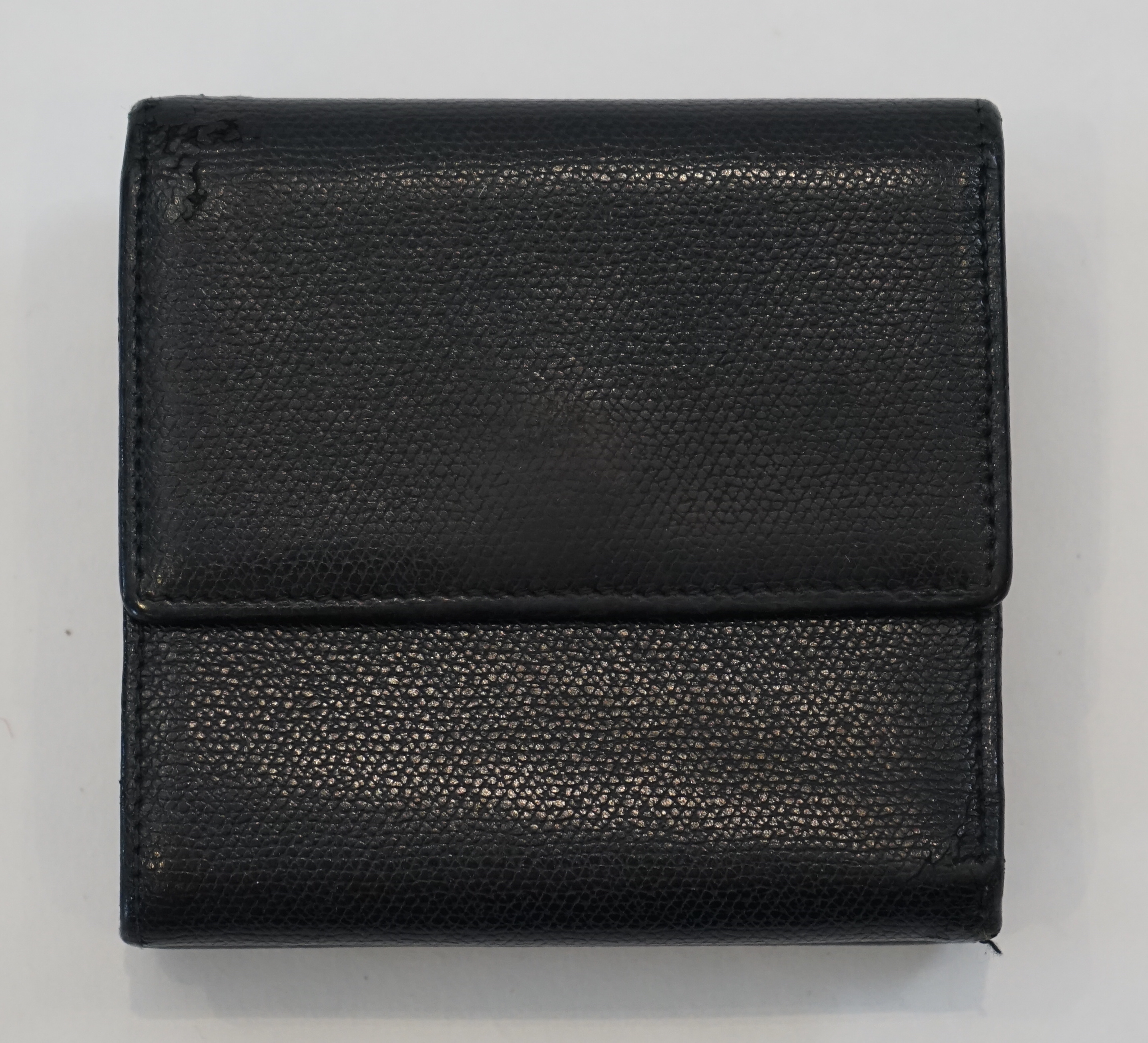 A Chanel black leather folded wallet width 10cm, depth 2cm, height 9.5cm